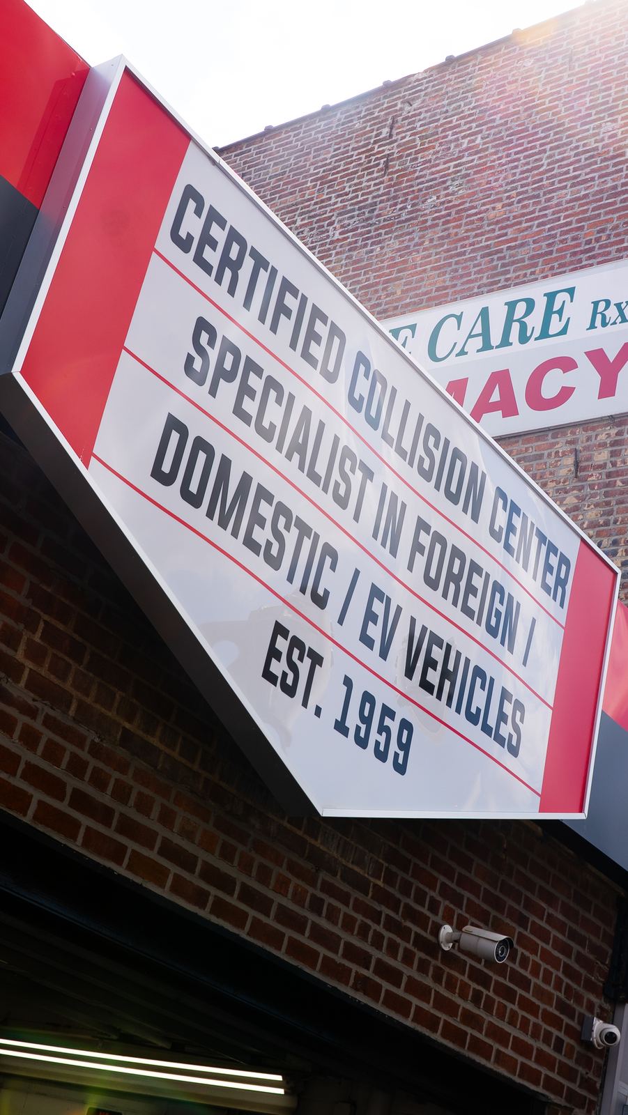 Signage for a certified collision specialist auto shop established in 1959, NYC