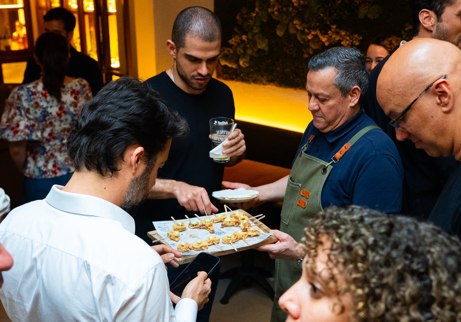 Server passing a tray of canapés at a NYC restaurant event, shot for a Getalife Studios client