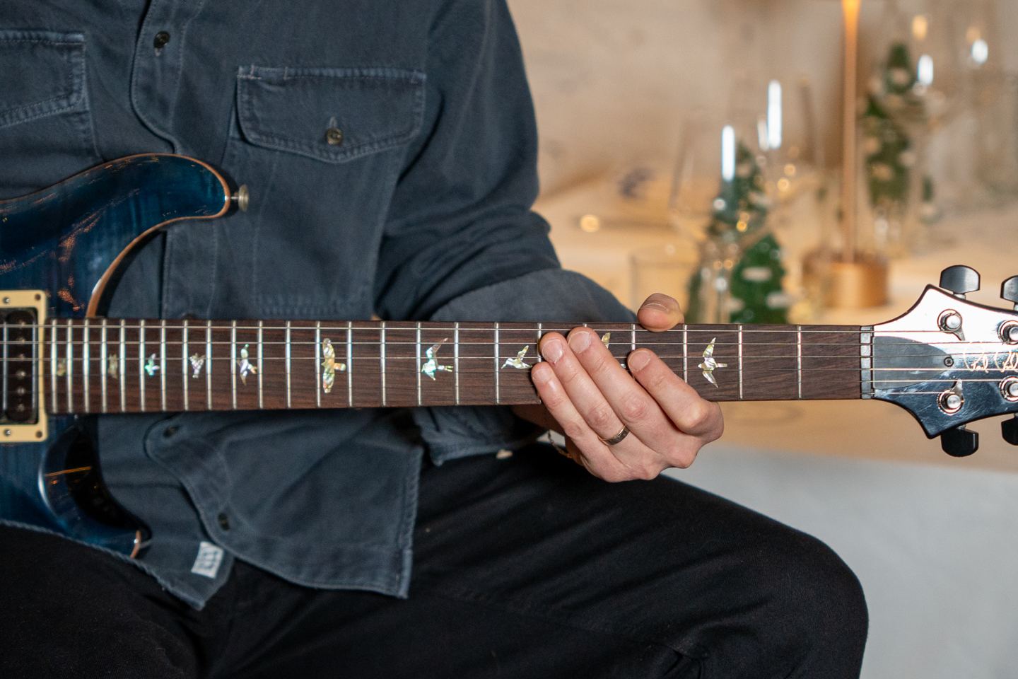 Close-up of a guitarist's hand on the fretboard during a live restaurant event in NYC