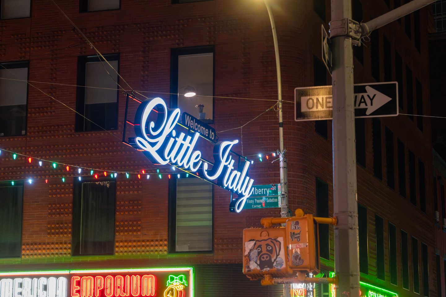 Illuminated neighborhood sign near a NYC restaurant client