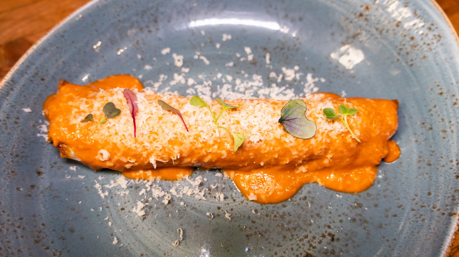 Plated dish with sauce and microgreens at a NYC restaurant client