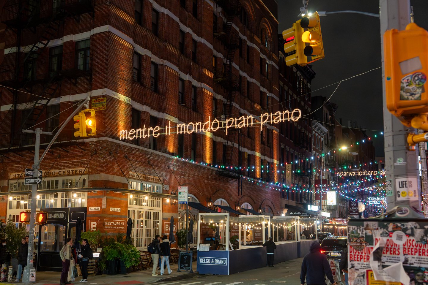 Neon signage lit up on the street outside a NYC restaurant client